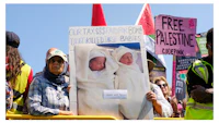 a group of people holding signs in front of a building