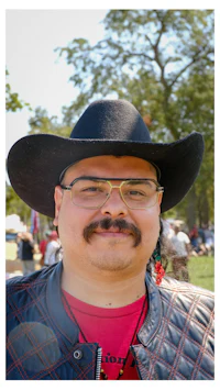 a man wearing a black cowboy hat